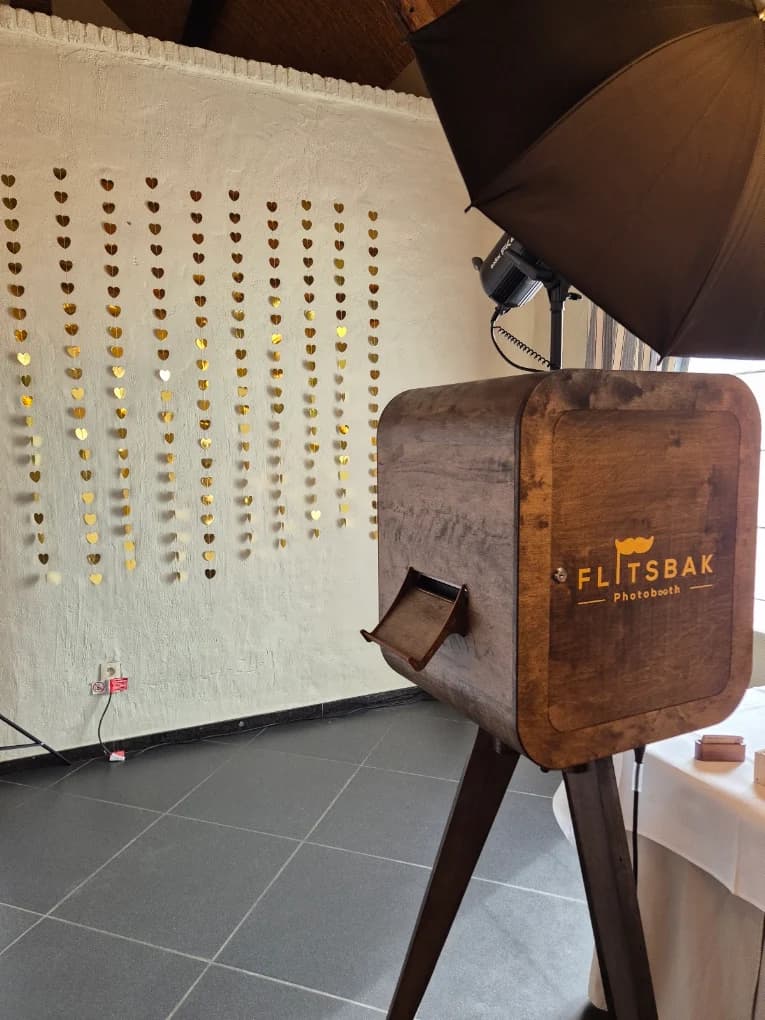 Flitsbak-booth bij een wand met gouden hartjes
